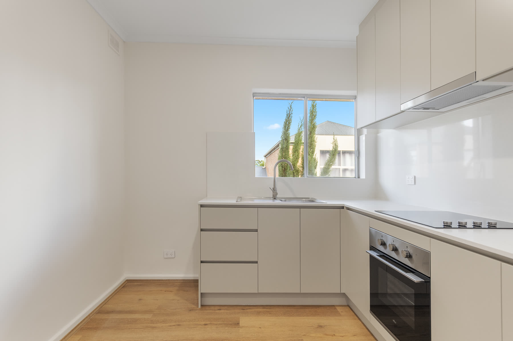 Renovated kitchen with new cabinetry and timber flooring